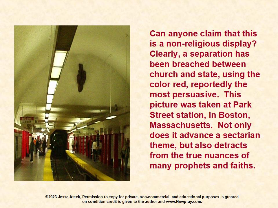 Boston's Park Street Red Line Stop - An undesirable religious display, shown on the northbound side looking back toward Downtown Crossing.  An apparently Catholic priest's hand, sculptured in wood is placed superior to riders waiting on the platform.  The display is a clear breach of separation between religious bias and government services.